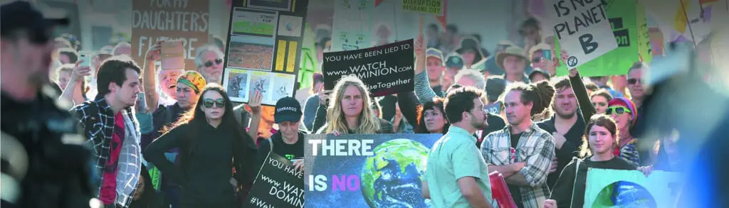 A group of people holding signs and protesting.