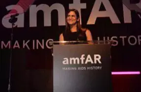 A woman standing at the top of a podium.