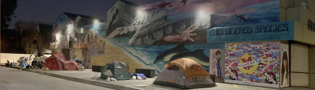A tent and some tents in front of a mural.