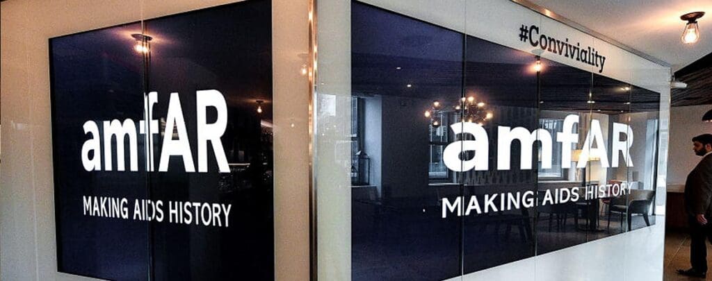AmfAR logo on black glass panels.